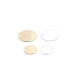 Four round metal tags in gold and silver on a white background