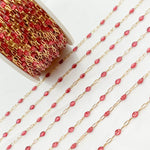 Gold chain with red beads on a white background