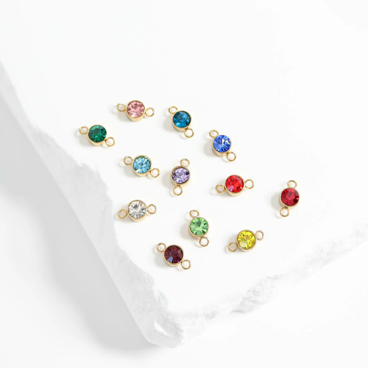 Set of colorful gemstone charms on a white background