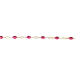 Gold chain with red gemstones on a white background