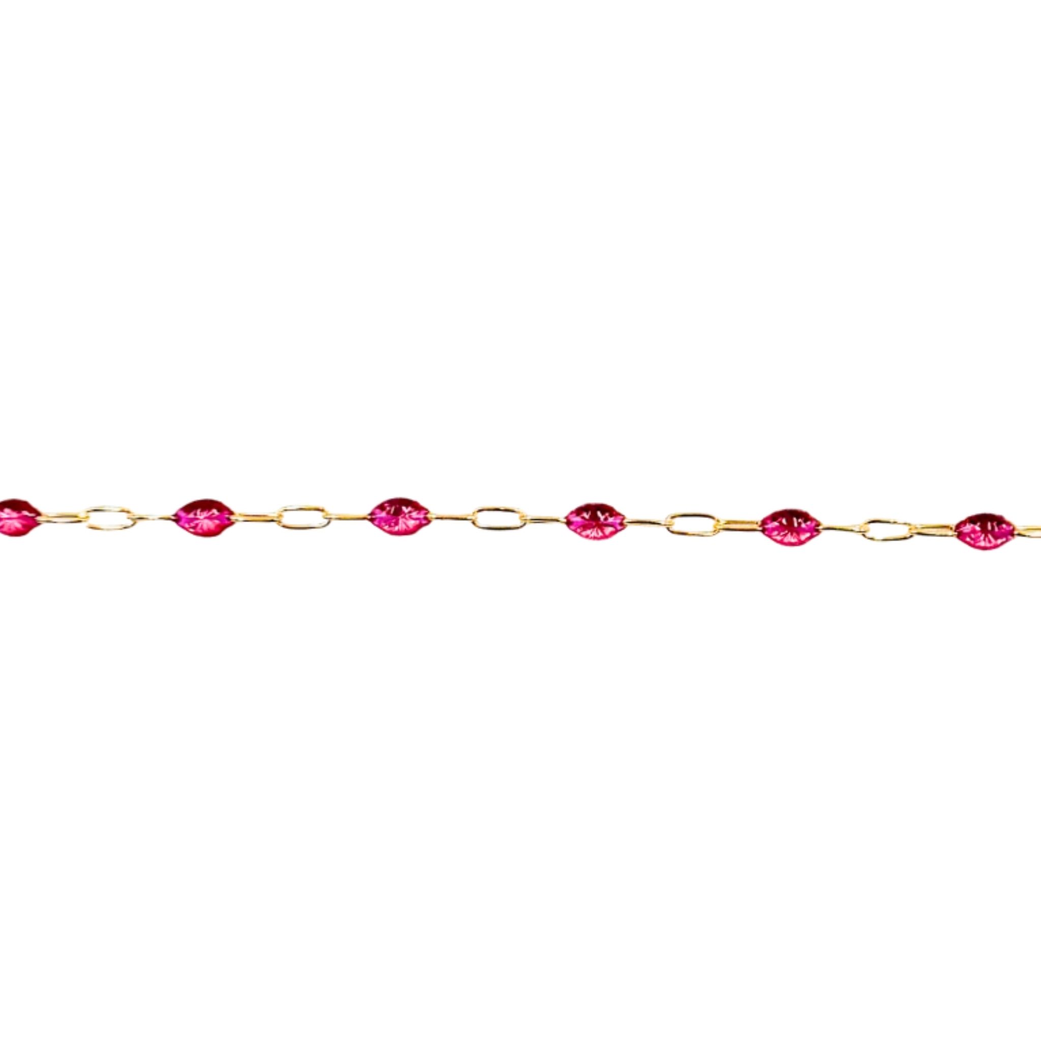 Gold chain with red gemstones on a white background