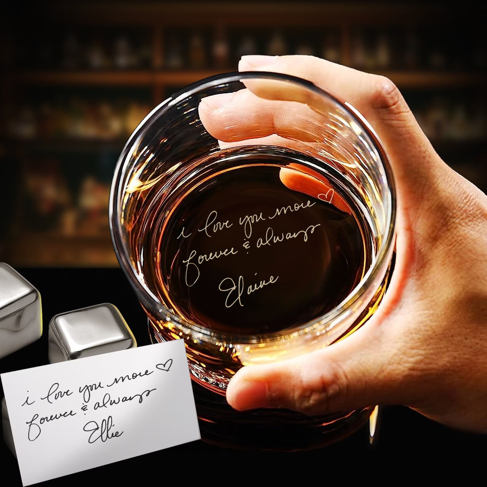 Hand holding a glass of whiskey with a personalized message, set against a blurred bar background.