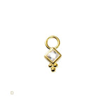 Gold charm with a square cut gemstone on a white background