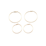 Four gold hoop earrings on a white background