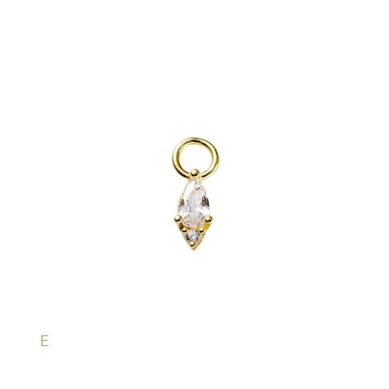 Gold pendant with a clear gemstone on a white background