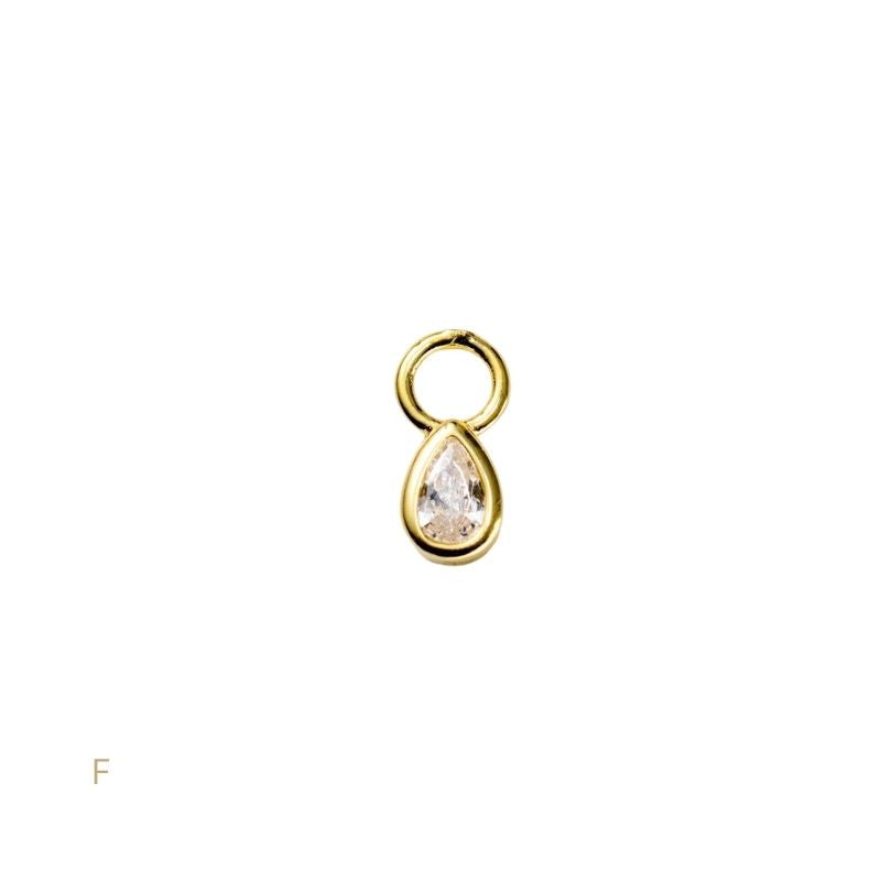 Gold teardrop-shaped pendant on a white background