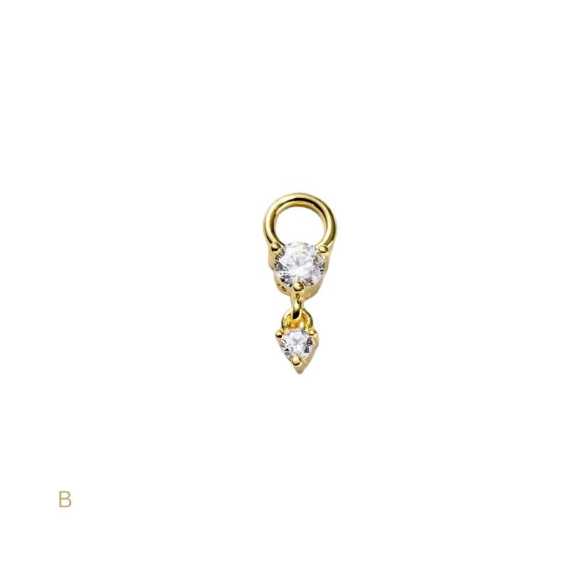 Gold earring with two clear gemstones on a white background