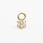 A gold flower-shaped charm with a circular ring attachment, featuring clear round-cut gemstones, set against a plain white background.