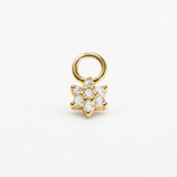A gold flower-shaped charm with a circular ring attachment, featuring clear round-cut gemstones, set against a plain white background.