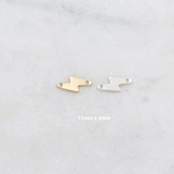 Gold and silver shoe-shaped charms on a light gray background