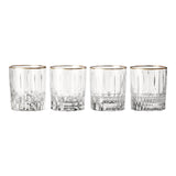 Four clear glass tumblers with gold rims on a white background