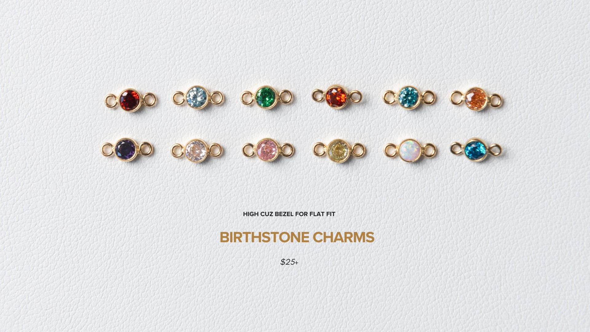 Collection of birthstone charms on a light gray background