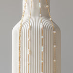 A close-up image of a bracelet with interlocked gold chains against a light background.