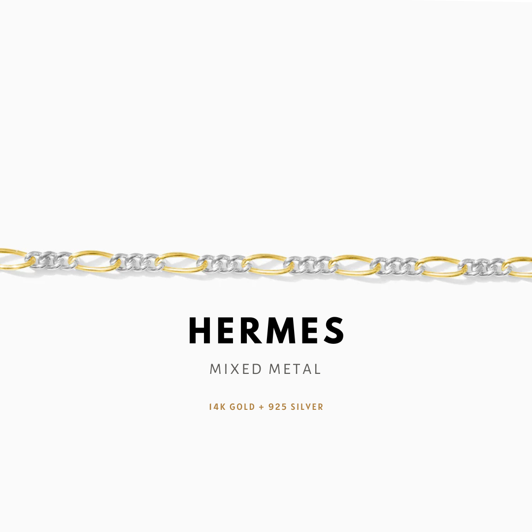 Hermes mixed metal bracelet with gold and silver links on a white background