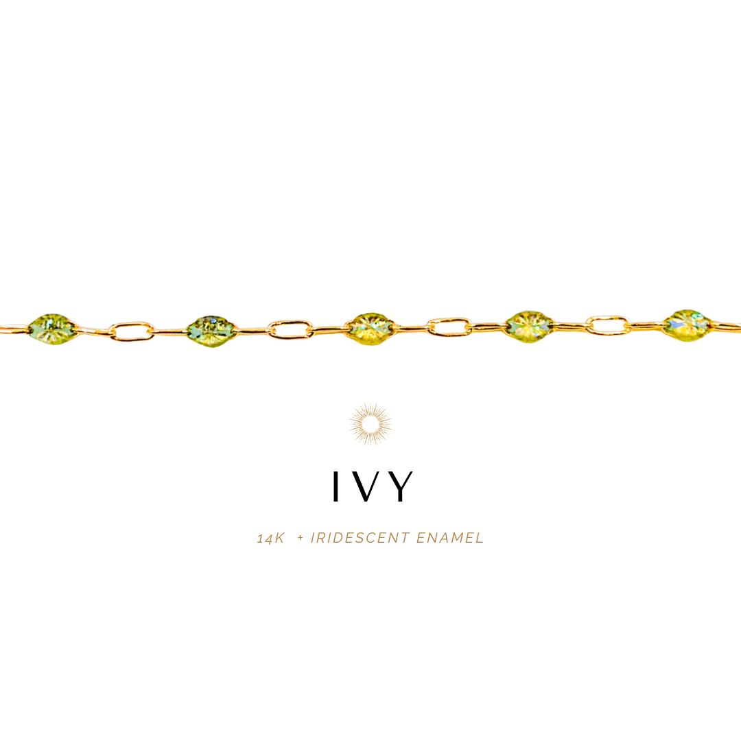 Gold bracelet with green gemstones on a white background, featuring the brand 'IVY'.