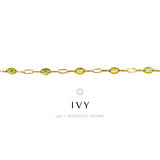 Gold bracelet with green gemstones on a white background, featuring the brand 'IVY'.