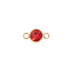 Gold jewelry connector with a red gemstone on a white background