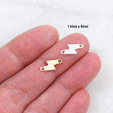 Two small metal clips on a person's hand with dimensions '11mm x 4mm' displayed.