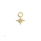 Gold star-shaped pendant with embedded stones on a white background