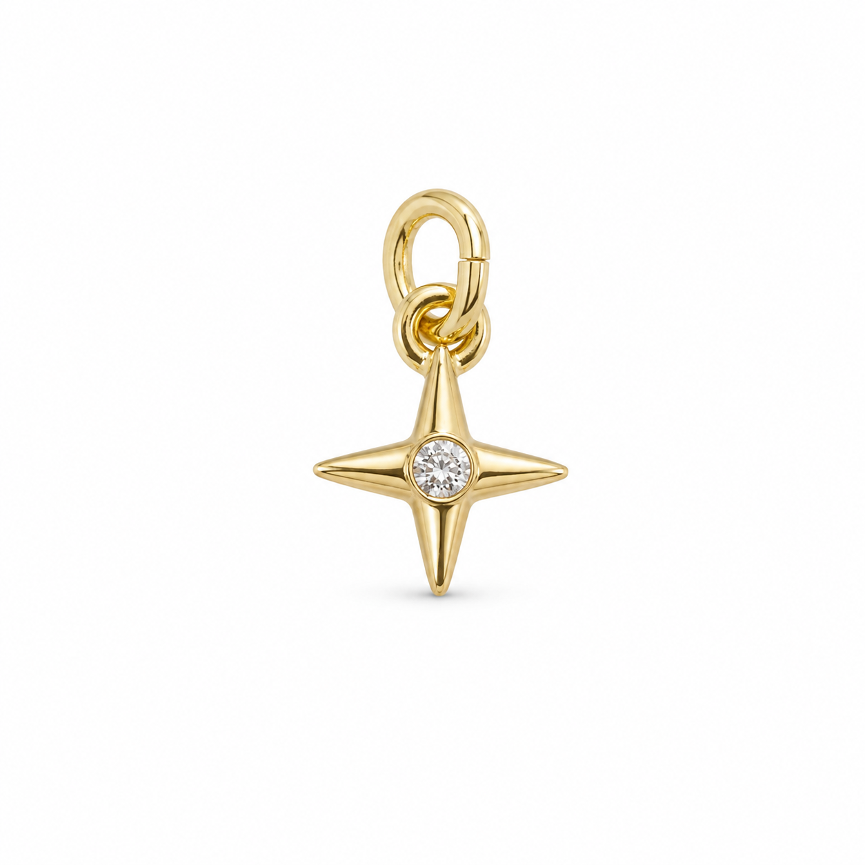 A gold four-pointed star charm pendant featuring a small clear round-cut gemstone at the center, suspended from a gold clasp loop, shown on a plain white background.