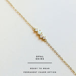 Gold permanent bracelet with opal stones on a white background, branded 'Opal Skies'.