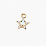 A gold star-shaped charm pendant featuring a central iridescent white opal and clear cubic zirconia stones, shown on a clean white background.