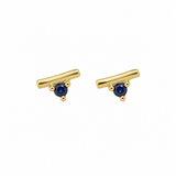 A pair of gold-toned stud earrings with a curved bar design and a small round dark blue gemstone at the center, set against a plain white background.