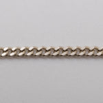 A silver curb-link chain bracelet with the brand name 'CASH' prominently displayed in the center.