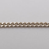 A silver curb-link chain bracelet with the brand name 'CASH' prominently displayed in the center.