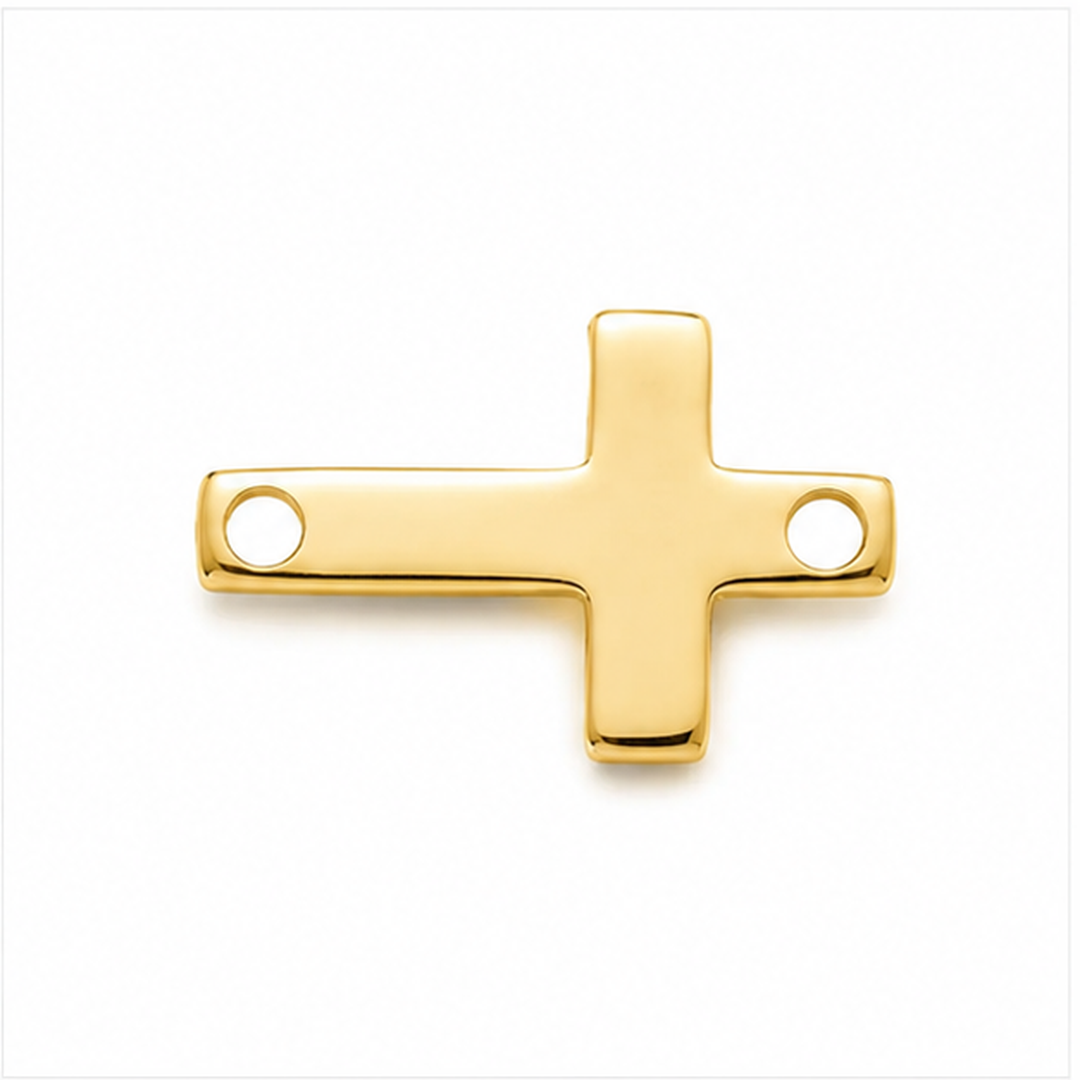 A polished gold cross pendant with two circular holes, shown on a clean white background.