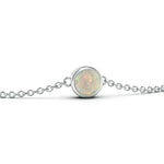 A collection of birthstone charms in gold and silver settings, featuring various colored gemstones.